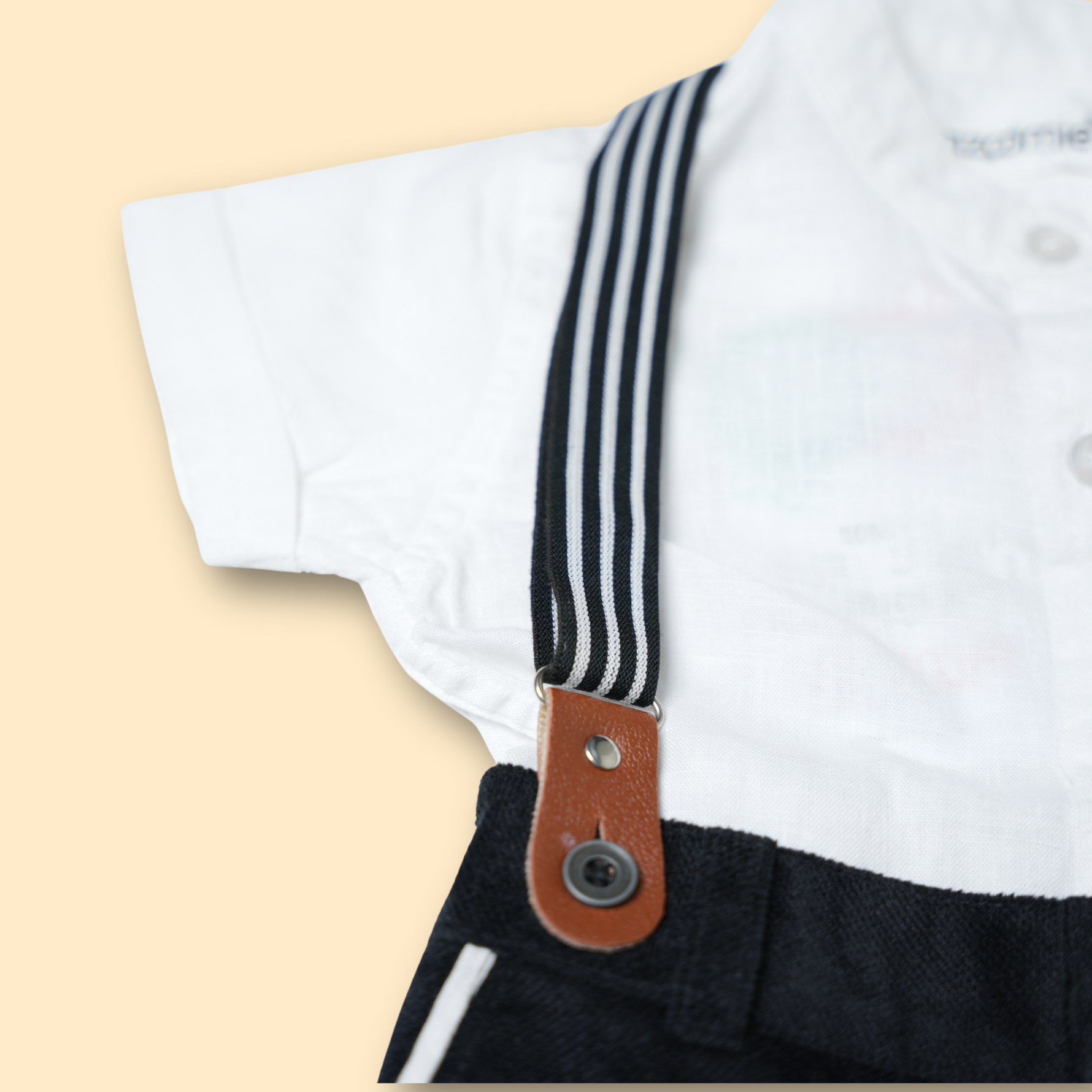 boys white button-up shirt with black shorts and striped suspenders set