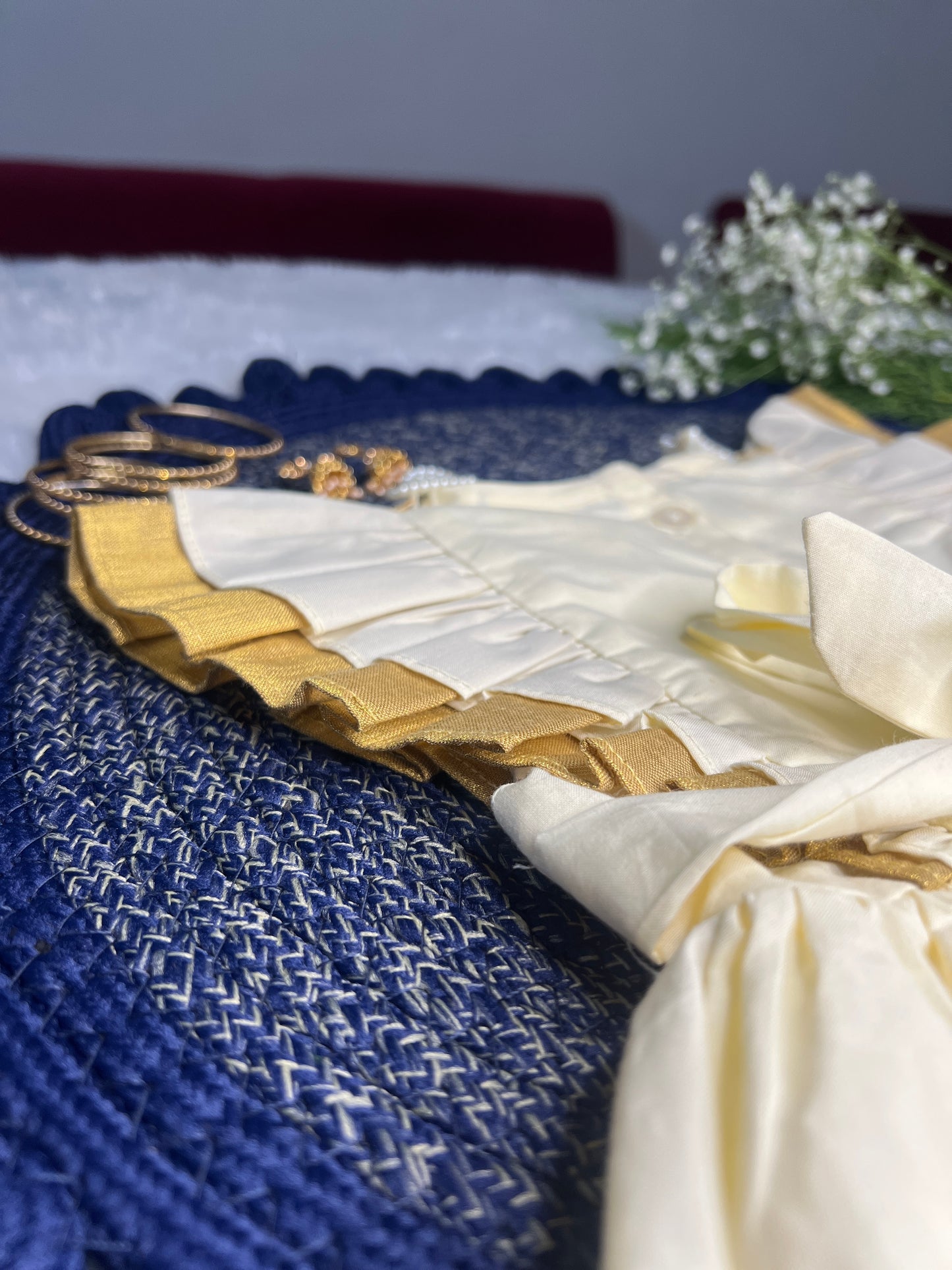 Close-up of a blue and gold fabric with decorative elements on a dark background