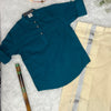 Teal shirt with White Dhothi on a textured surface with a  flute.