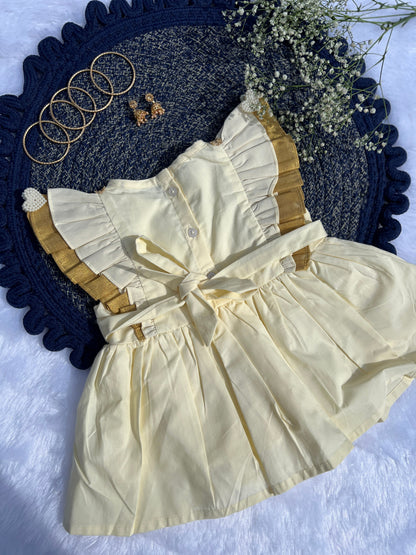 White dress with gold trim on a textured blue surface