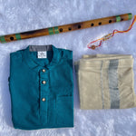 Teal shirt, beige fabric, and wooden flute on a textured white surface