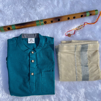 Teal shirt, beige fabric, and wooden flute on a textured white surface