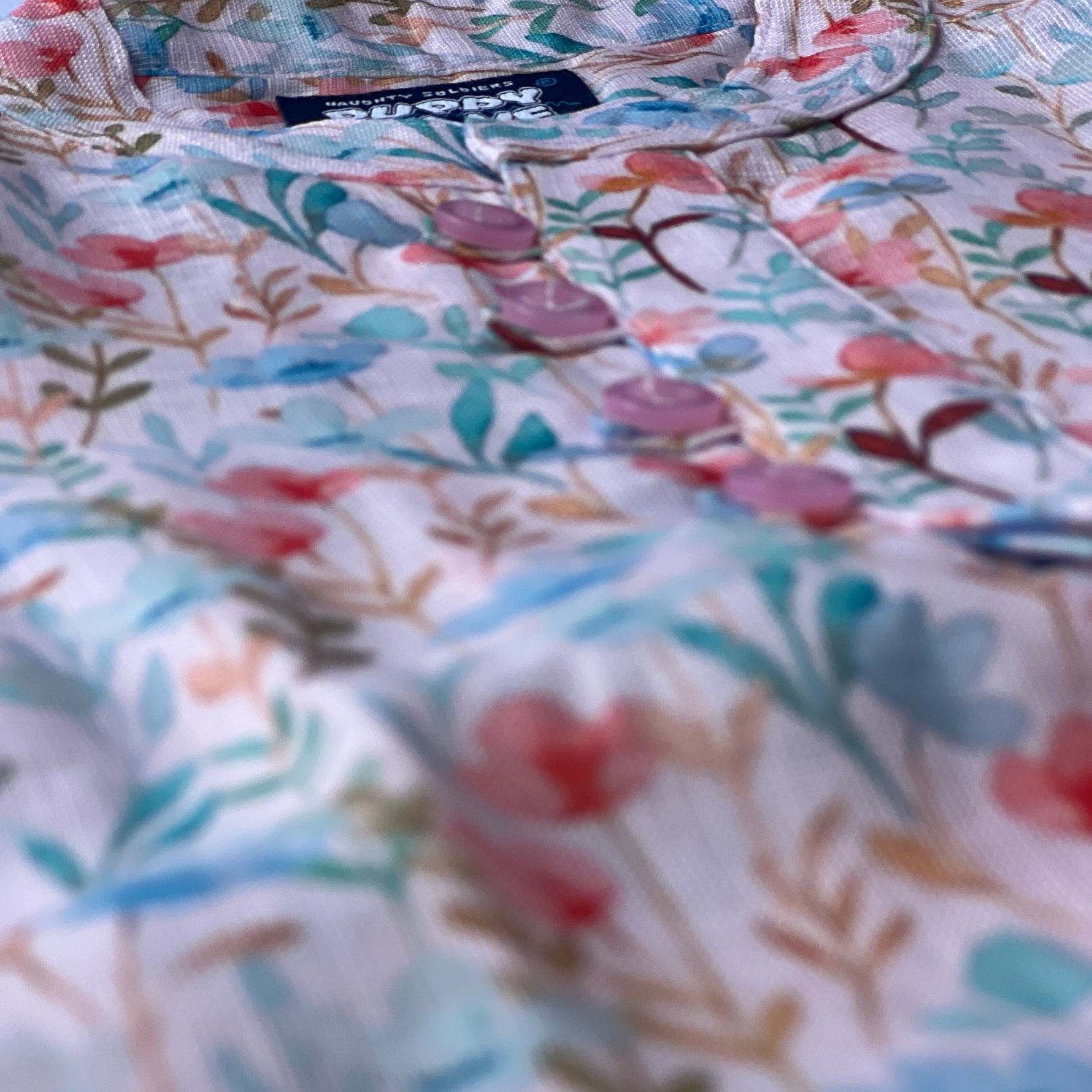 Close-up of a floral-patterned shirt with a blurred background