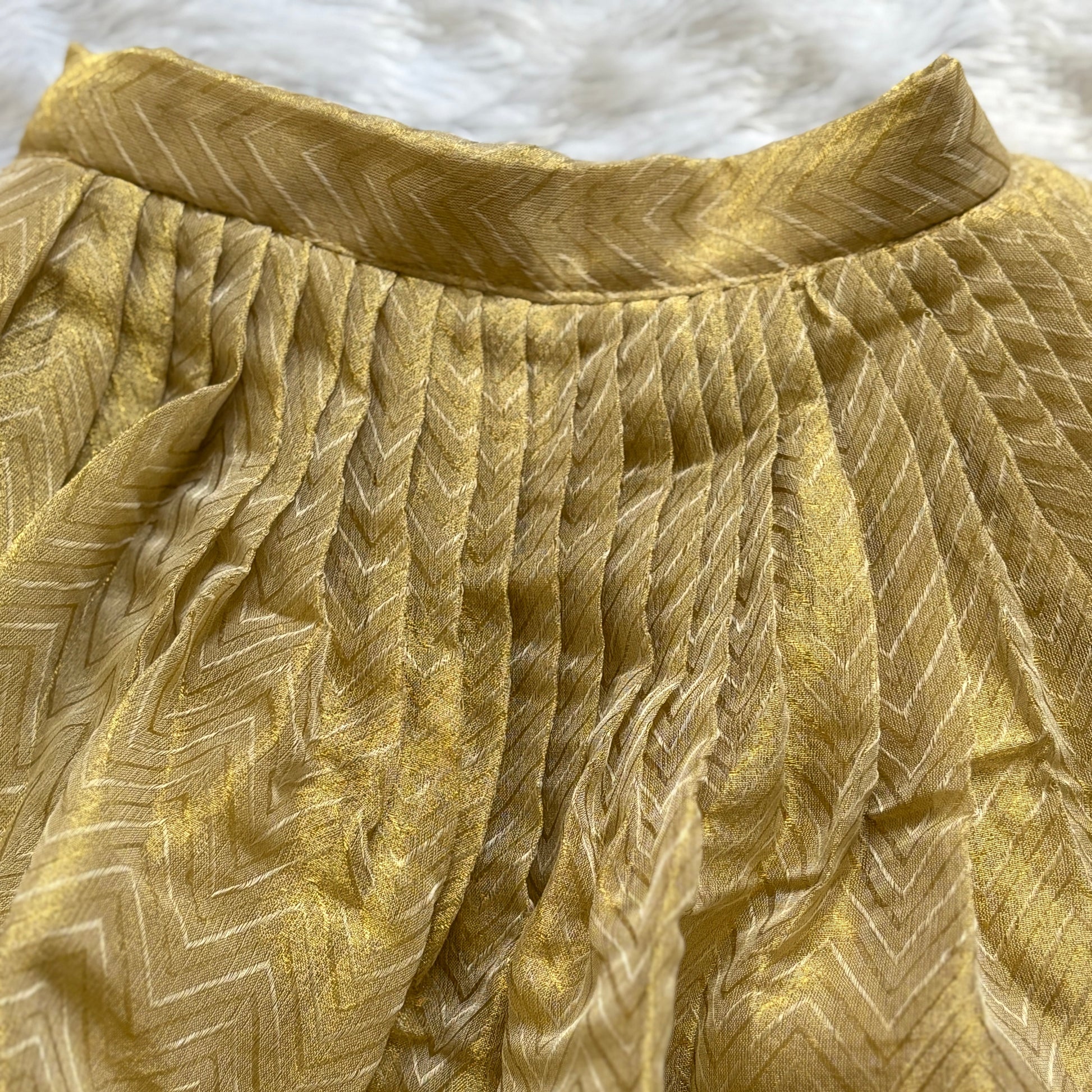 Close-up of a textured gold fabric with a pattern