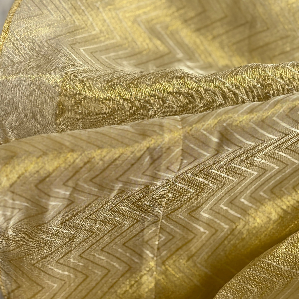 Close-up of gold fabric with zigzag pattern