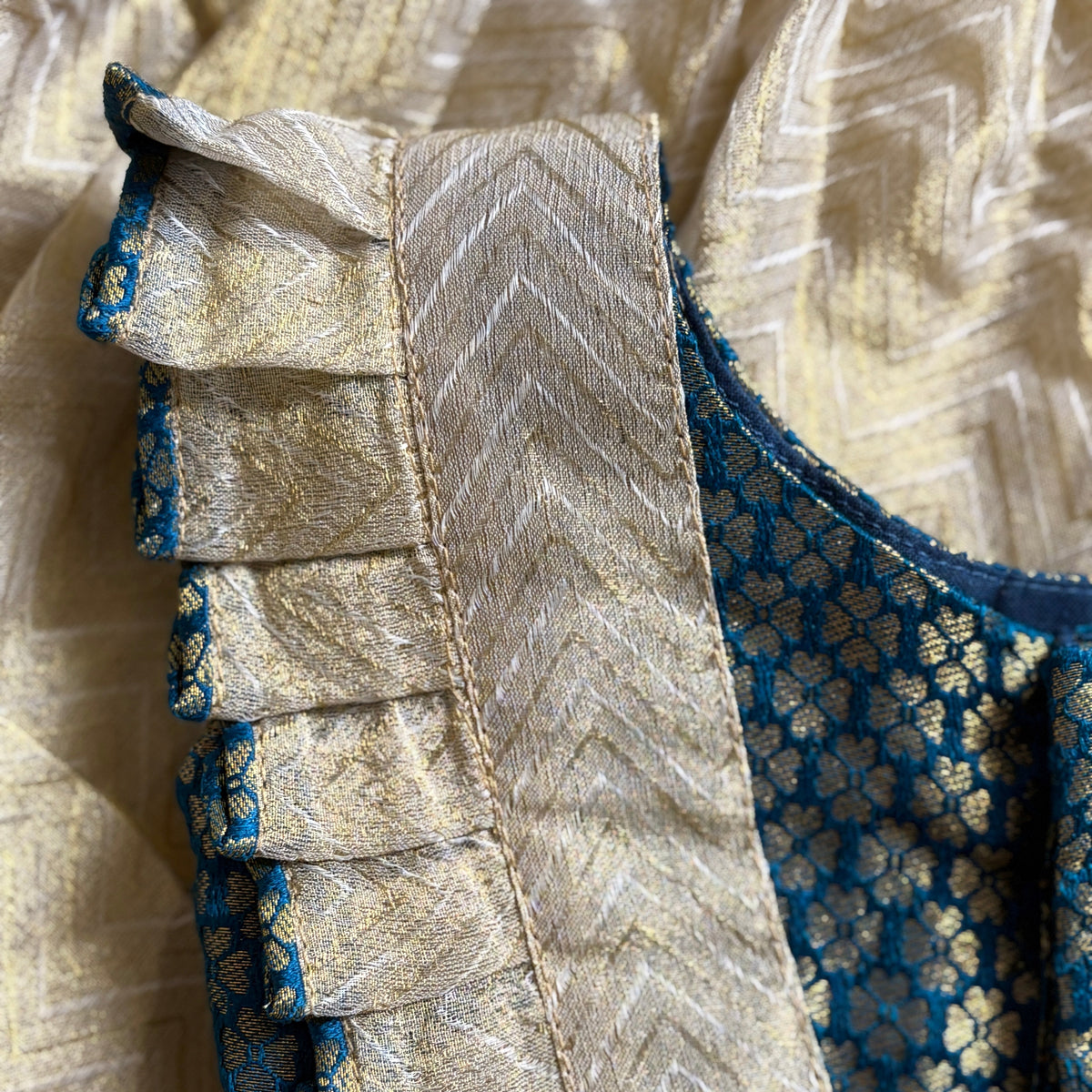 Close-up of a fabric edge with intricate patterns and colors.