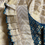 Close-up of a fabric edge with intricate patterns and colors.