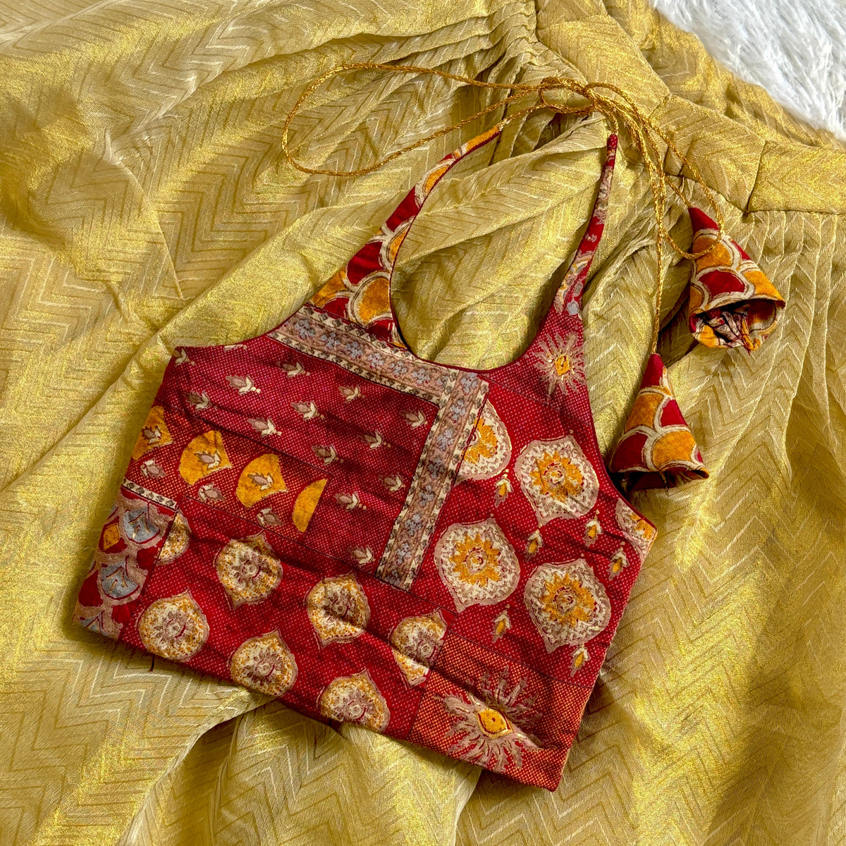Red embroidered blouse with yellow fabric in the background