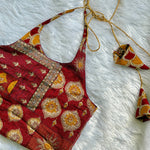 Red patterned fabric with gold accents on a white textured background
