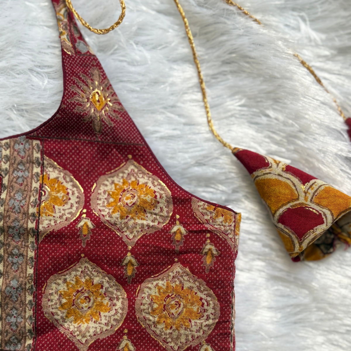 Decorative fabric with intricate patterns on a white textured surface